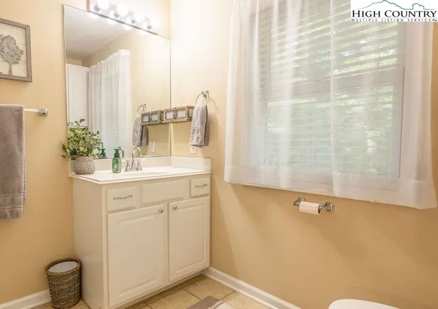 a bathroom with a sink and mirror with toilet