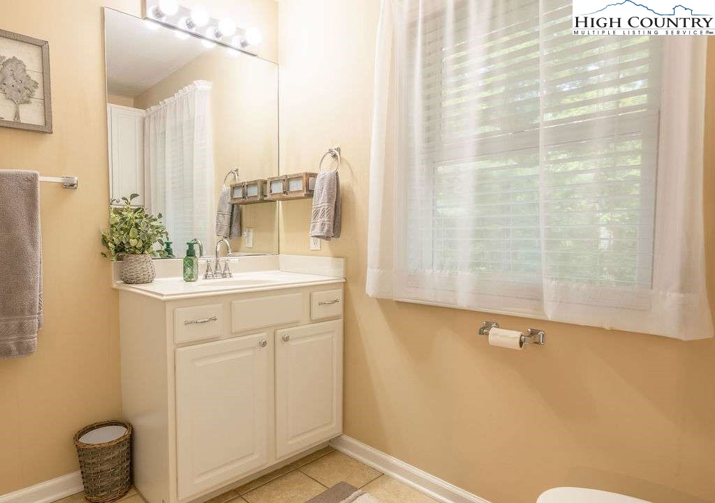 120 Ridge Road Newland, NC 28657 - Photo 6 of 40 a bathroom with a sink and mirror with toilet