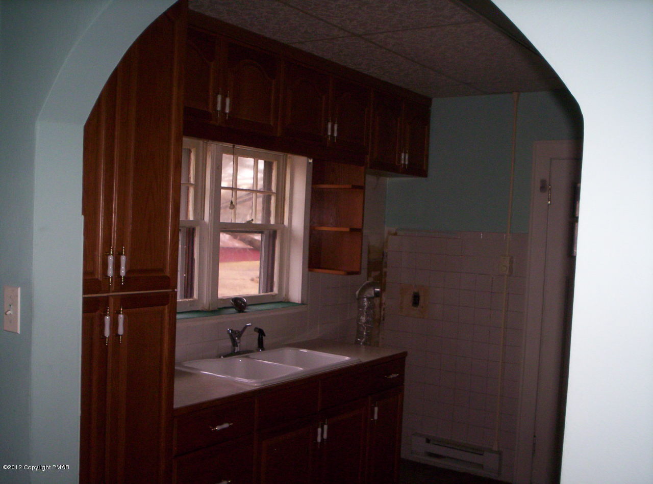Grange Rd Mount Mount Pocono, PA 18344 - Photo 6 of 8 a bathroom with a sink a mirror and next to a window