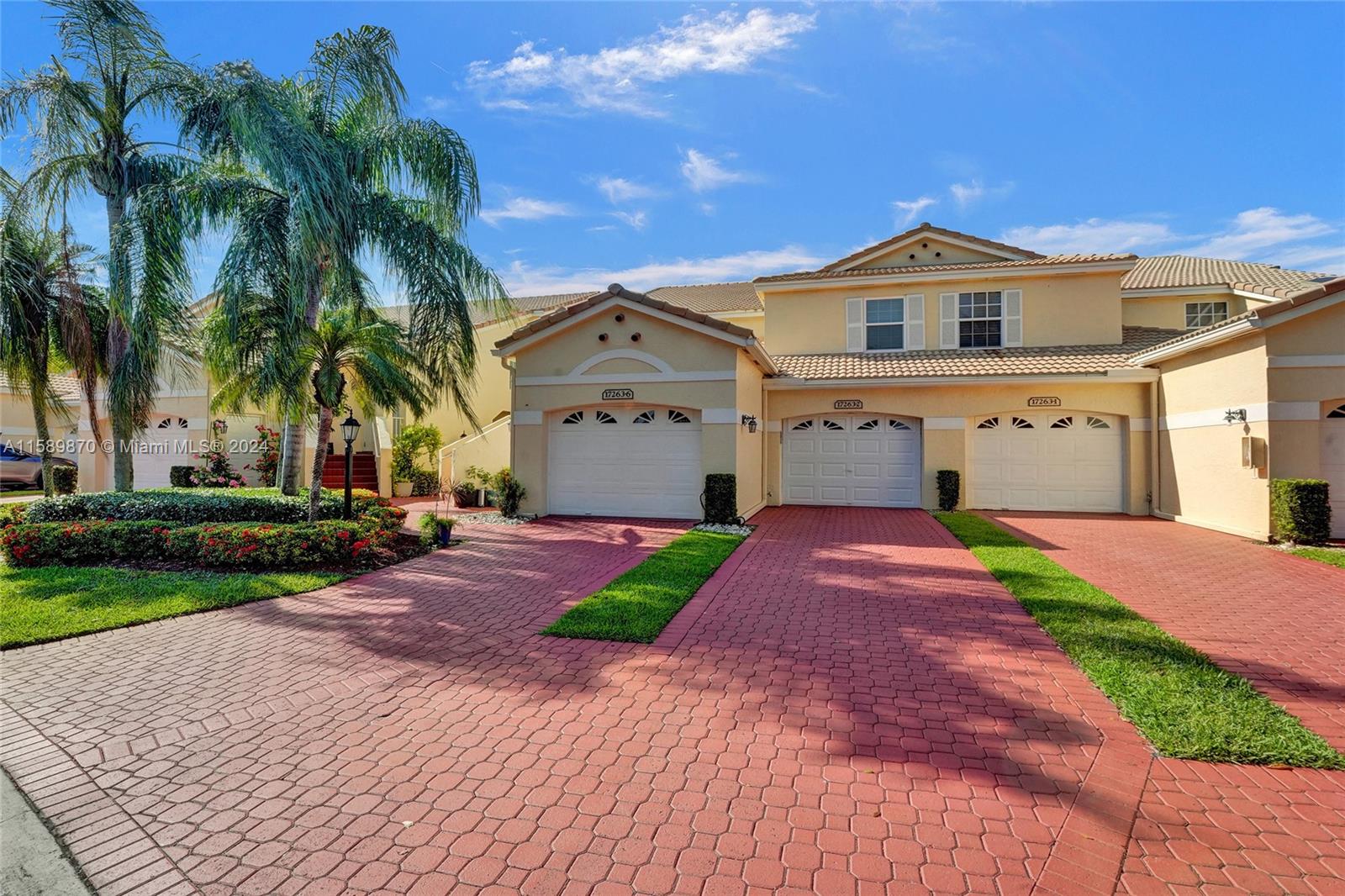 17263 Boca Club Boulevard, Unit 2 Boca Raton, FL 33487 - Photo 1 of 1 a front view of a house with a yard and garage