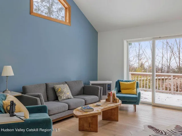 a living room with furniture and a floor to ceiling window