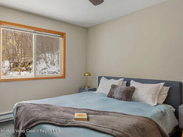 a bedroom with a bed and window