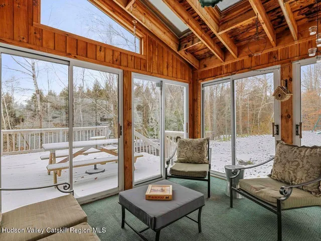 a living room with furniture and a floor to ceiling window