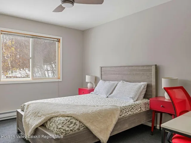 a bedroom with a bed a closet and window