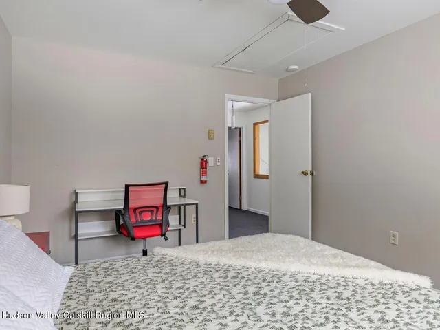 a bed room with a bed and a chair