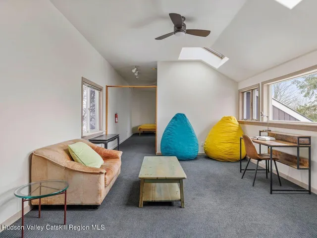 a living room with furniture and a lamp