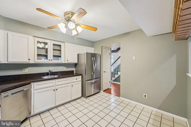 a bathroom with a toilet sink vanity tub and mirror