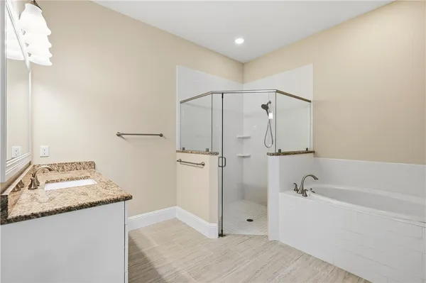 a bathroom with a granite countertop sink mirror and shower