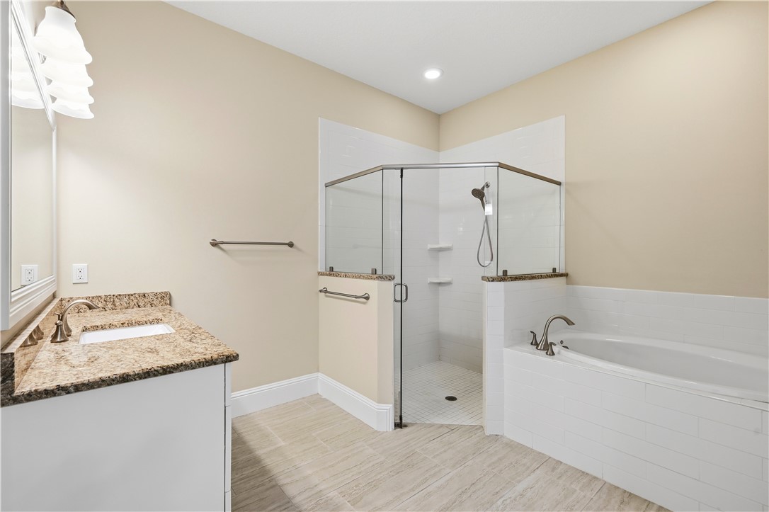 2030 Bridgepointe Circle, Unit 112 Vero Beach, FL 32967 - Photo 19 of 36 a bathroom with a granite countertop sink mirror and shower