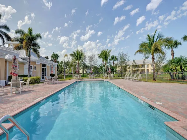 a swimming pool with outdoor seating and yard