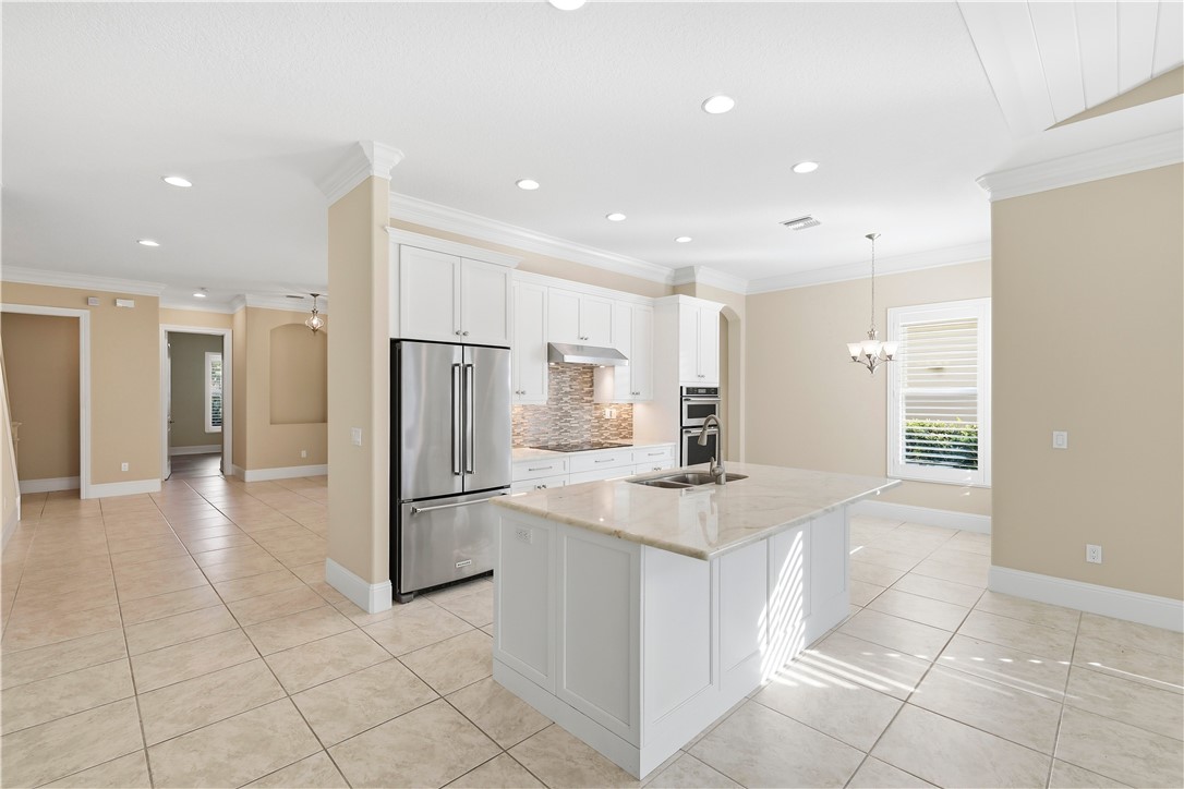 2030 Bridgepointe Circle, Unit 112 Vero Beach, FL 32967 - Photo 6 of 36 a kitchen with stainless steel appliances a refrigerator and a sink