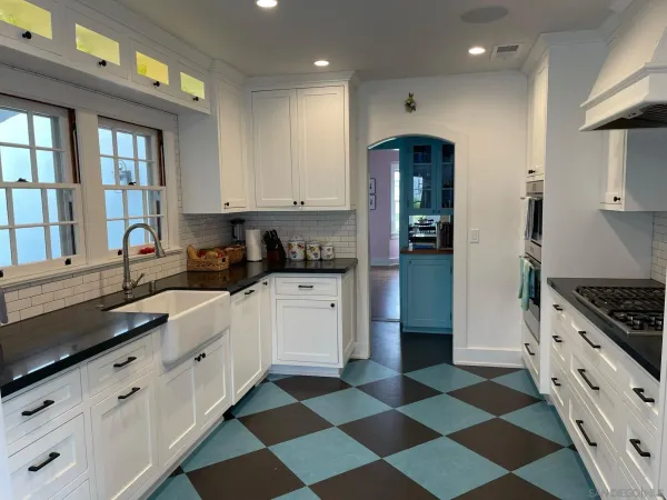 a kitchen with granite countertop stainless steel appliances and cabinets
