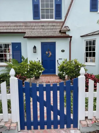 a front view of a house with a garden