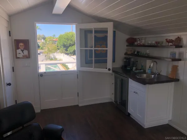 a kitchen with a sink and a stove top oven
