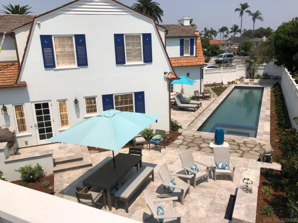 a view of a patio with table and chairs