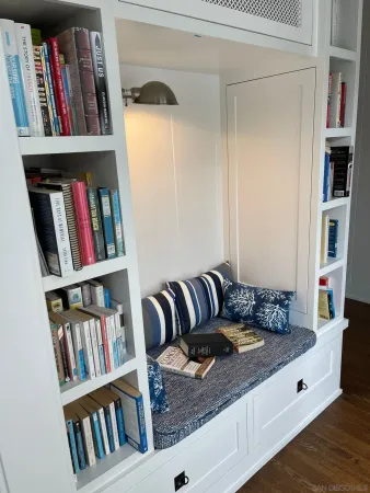 a living room with hard wood floor and bookshelf