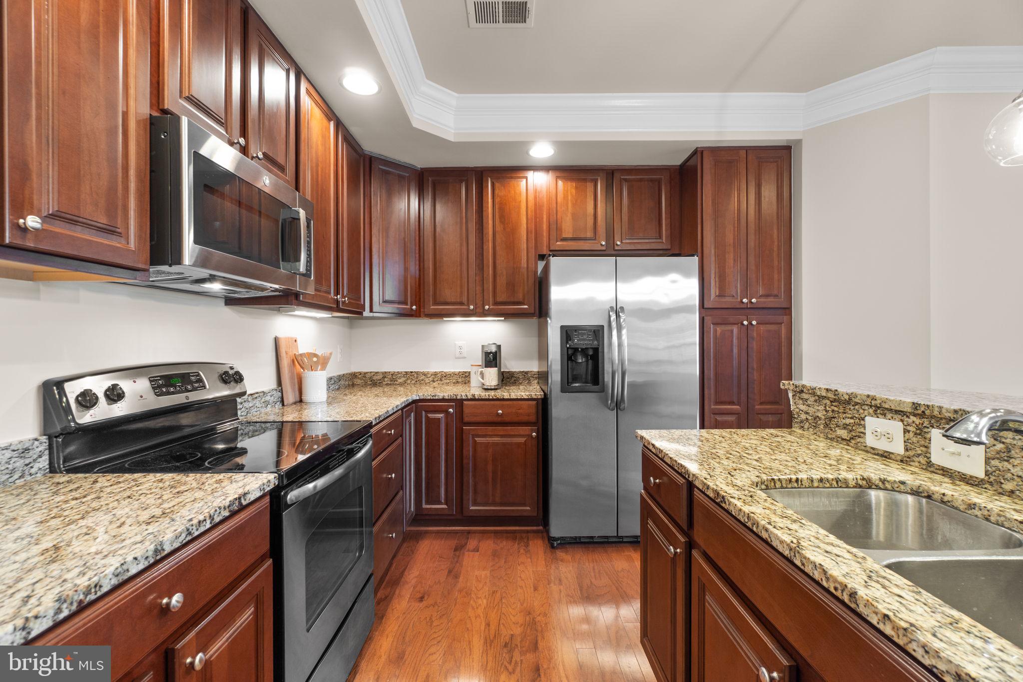 3624 Spring Hollow Lane Frederick, MD 21704 - Photo 11 of 46 a kitchen with stainless steel appliances granite countertop a sink stove and refrigerator