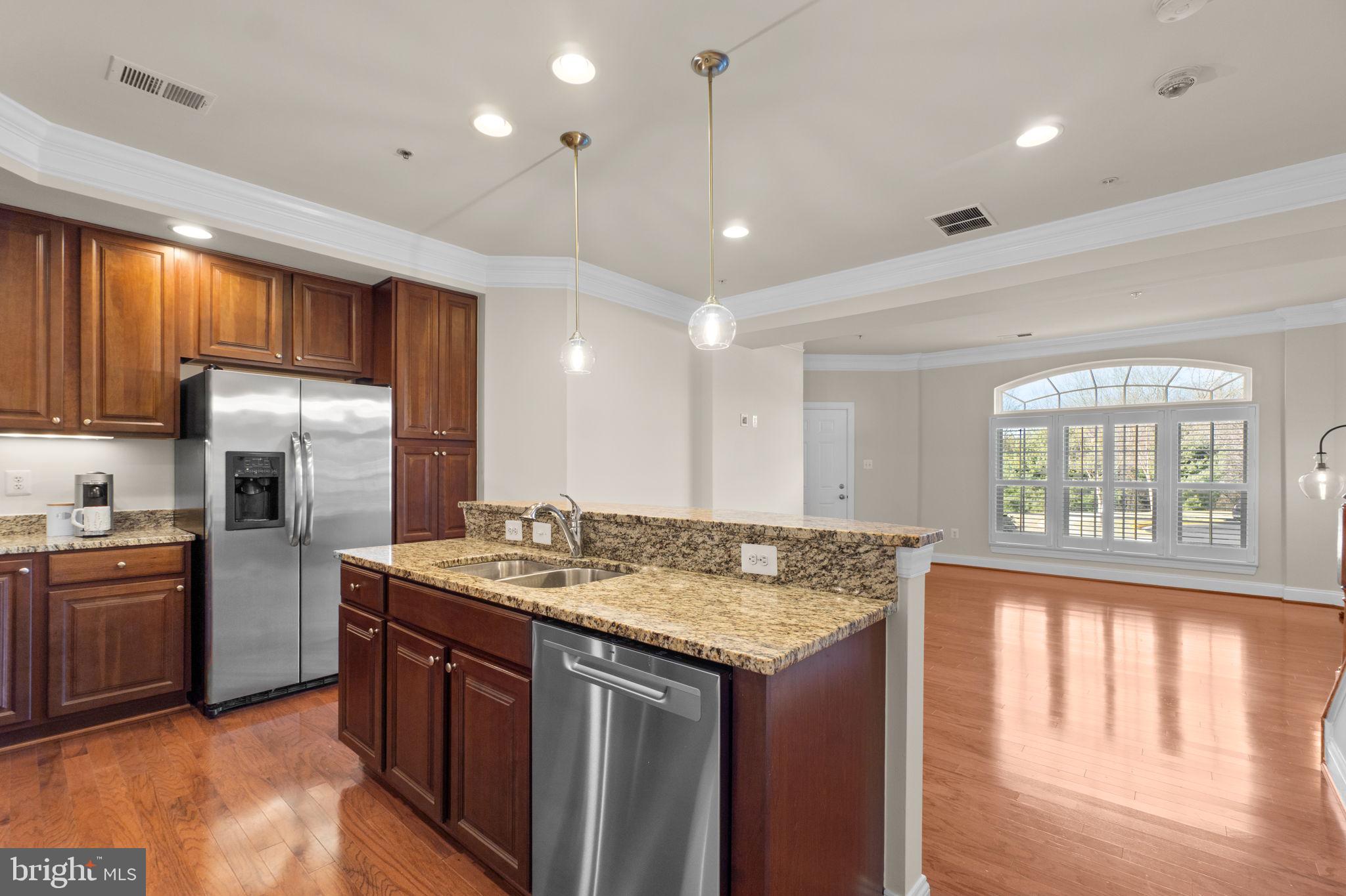 3624 Spring Hollow Lane Frederick, MD 21704 - Photo 12 of 46 a kitchen with stainless steel appliances granite countertop a sink stove and refrigerator