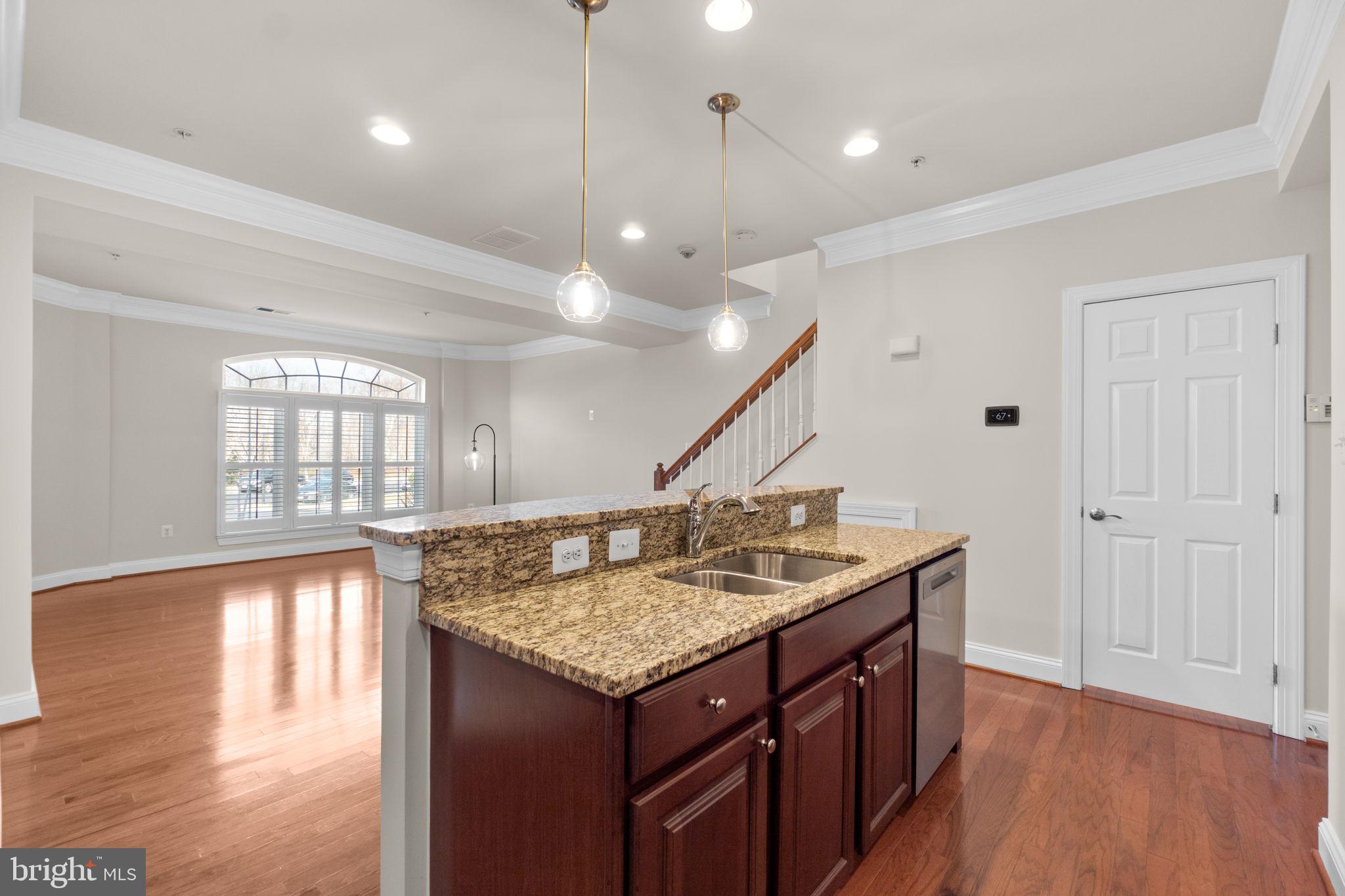 3624 Spring Hollow Lane Frederick, MD 21704 - Photo 13 of 46 a kitchen with a counter space wooden floor and a ceiling fan