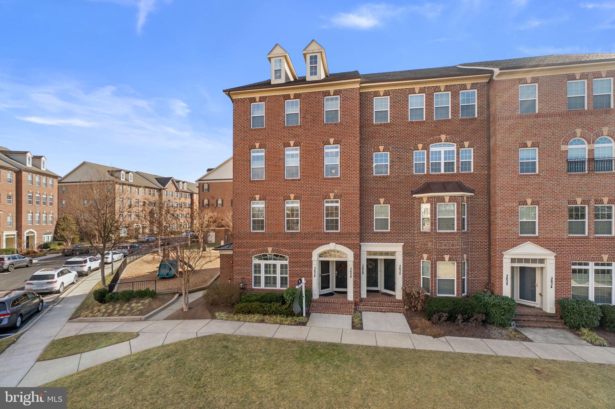 3624 Spring Hollow Lane Frederick, MD 21704 - Photo 2 of 46 a front view of a residential apartment building with a yard