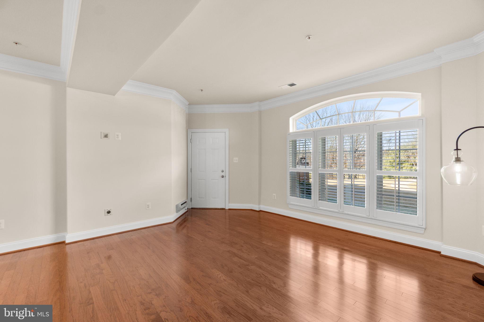 3624 Spring Hollow Lane Frederick, MD 21704 - Photo 8 of 46 wooden floor in an empty room with a window