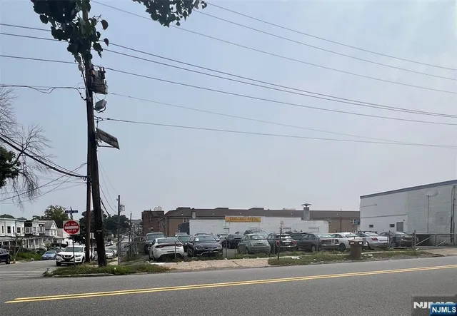 a view of a city street with a cars park side of road