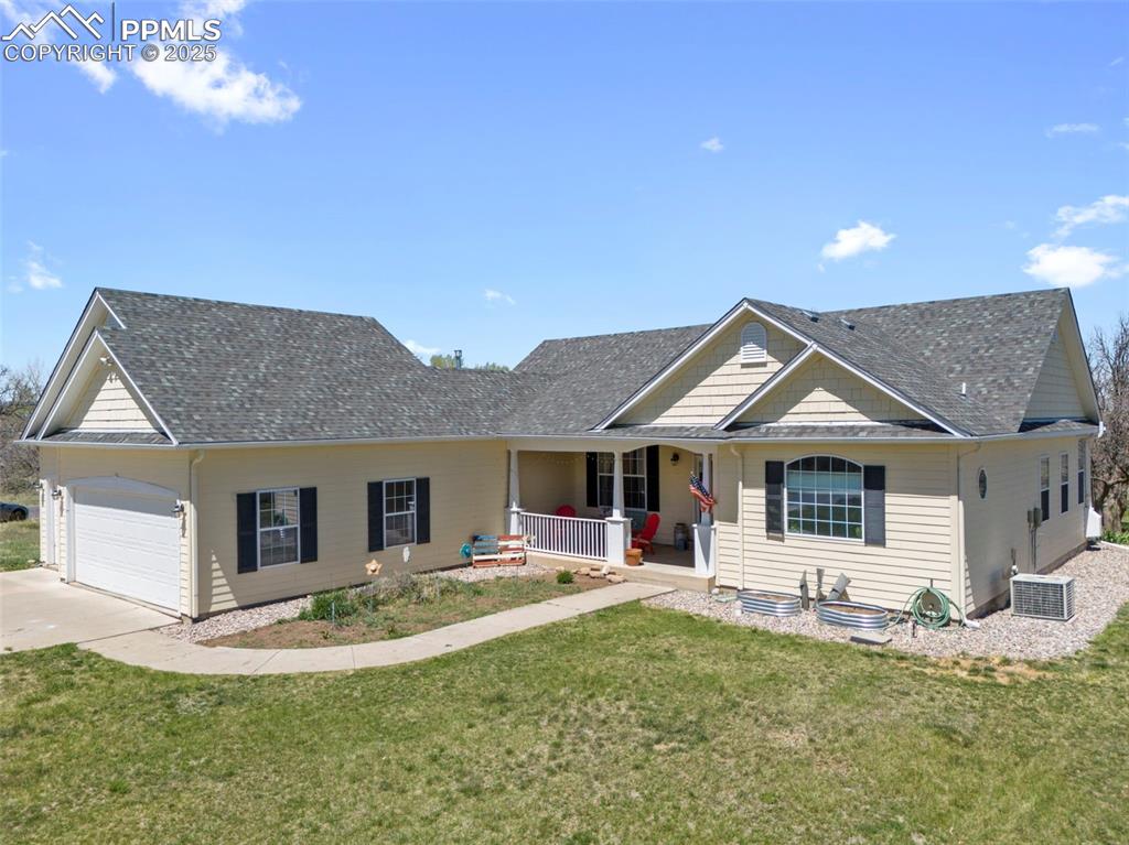 33 Riverdowns Colorado City, CO 81019 - Photo 2 of 45 a front view of a house with a yard and garage