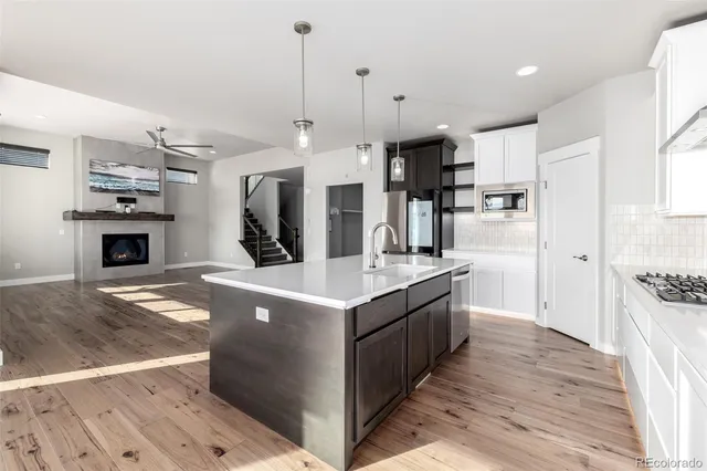 a kitchen with kitchen island granite countertop a sink and a stove