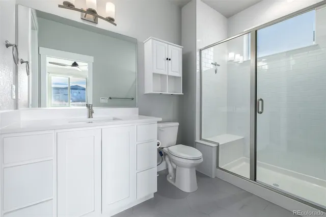 a bathroom with a sink toilet a mirror and shower