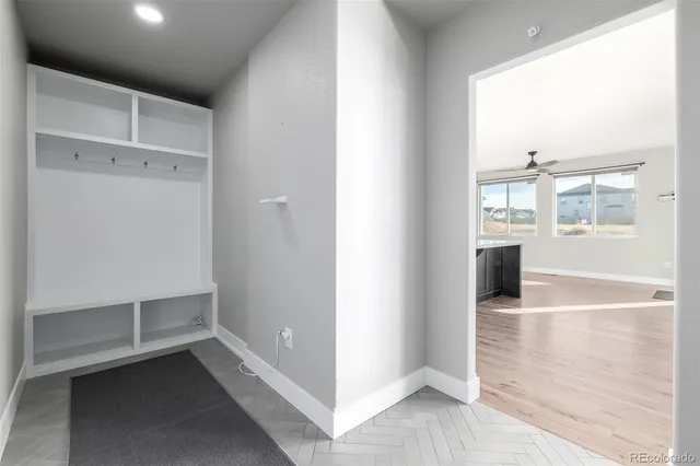 a view of a hallway view with wooden floor and staircase