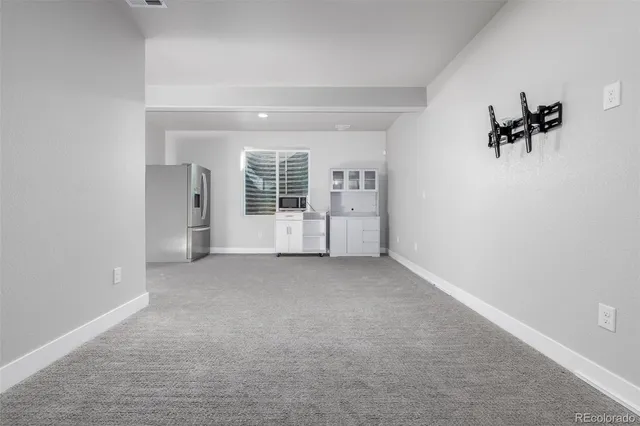 an empty room with windows and closet