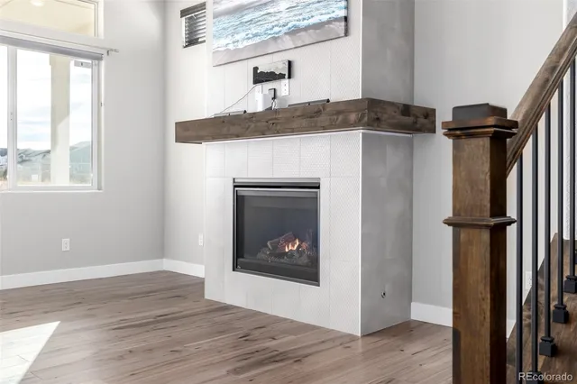 a living room with a fireplace furniture and a window