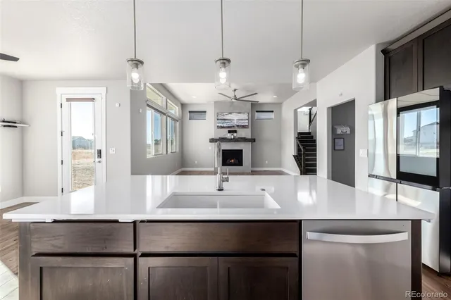 a view of a kitchen counter space a sink and appliances