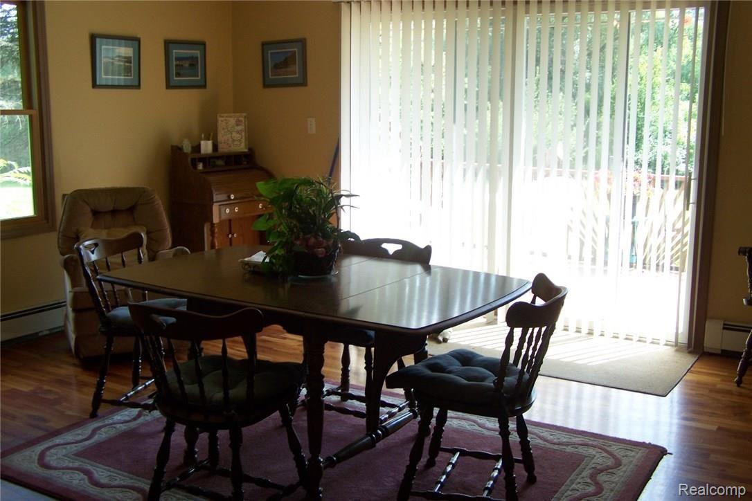 610 Young Road White Lake, MI 48383 - Photo 7 of 24 Very spacious dining opens to large kitchen. Has door wall and deck facing the lake.