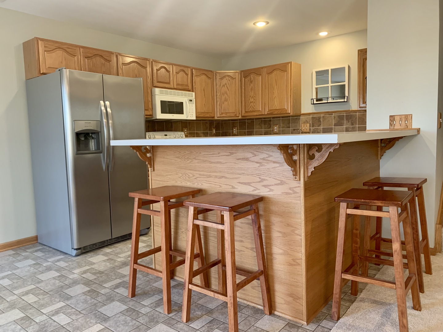 686 South Peace Road, Unit 686 Sycamore, IL 60178 - Photo 5 of 15 a kitchen with stainless steel appliances granite countertop a chairs a sink and a refrigerator
