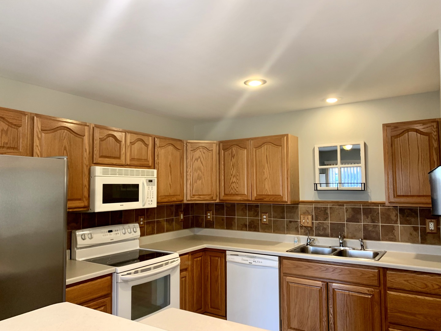 686 South Peace Road, Unit 686 Sycamore, IL 60178 - Photo 6 of 15 a kitchen with stainless steel appliances a sink stove and microwave
