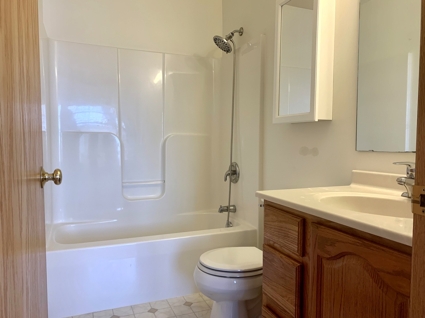 686 South Peace Road, Unit 686 Sycamore, IL 60178 - Photo 9 of 15 a bathroom with a sink toilet and shower