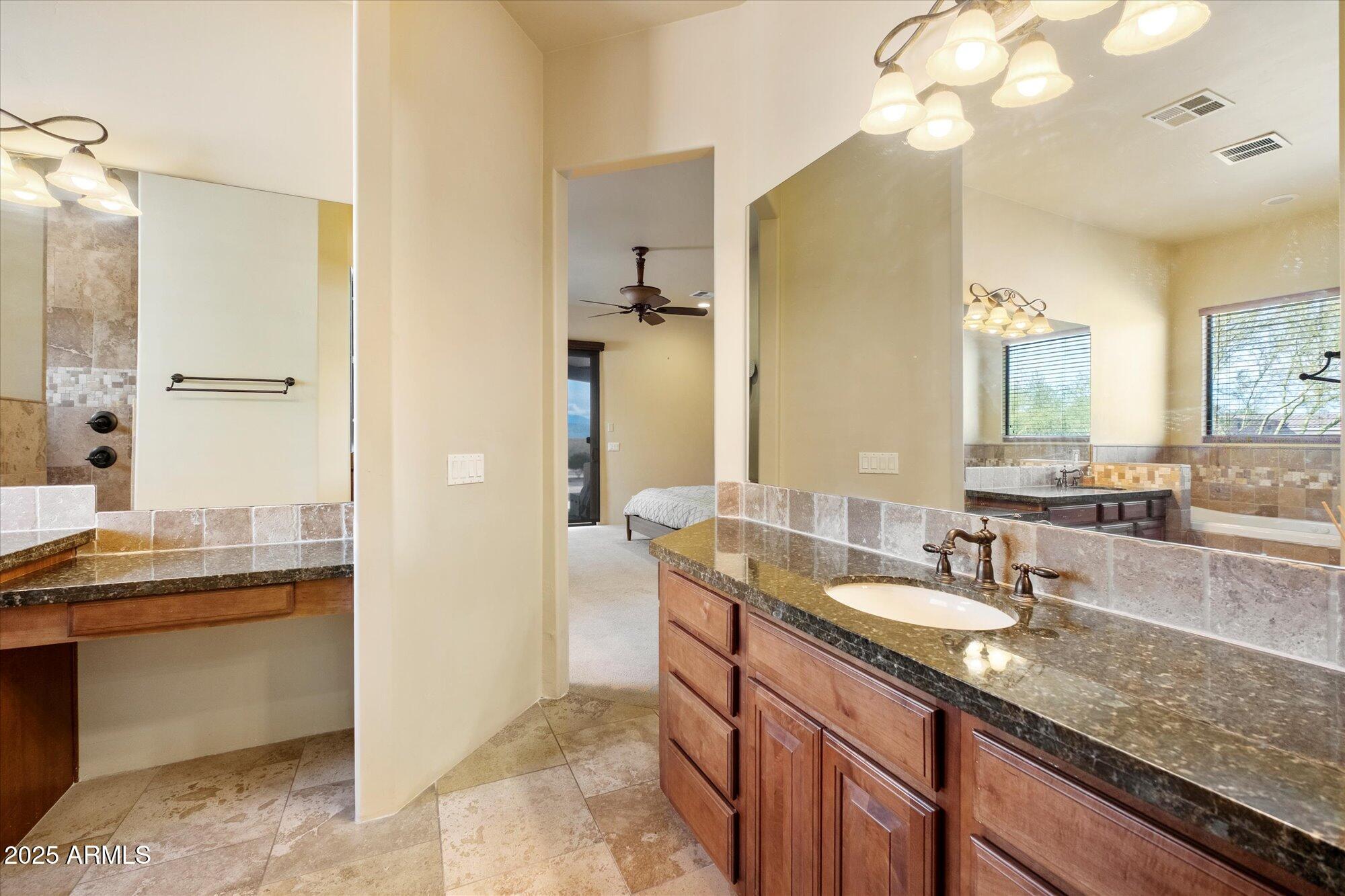 29317 North 164th Street Scottsdale, AZ 85262 - Photo 16 of 27 a bathroom with a granite countertop sink a mirror and a shower