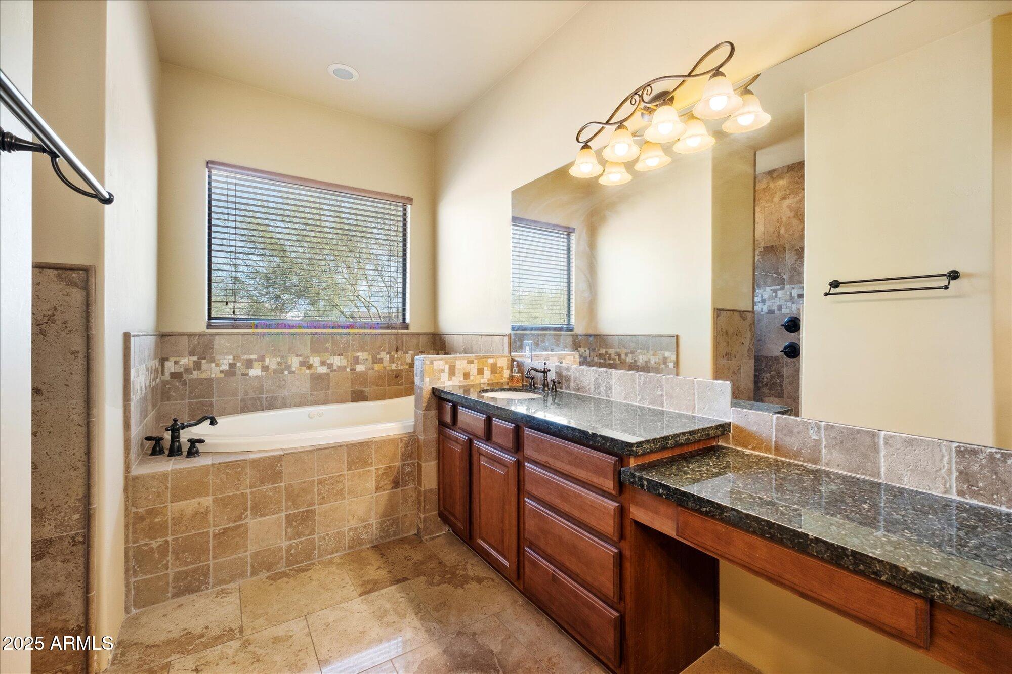 29317 North 164th Street Scottsdale, AZ 85262 - Photo 17 of 27 a bathroom with a granite countertop sink a large mirror and a bathtub