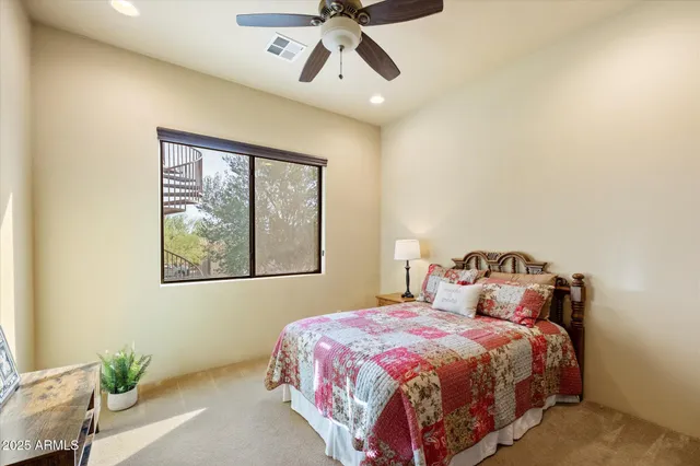 a bedroom with a bed and painting on the wall