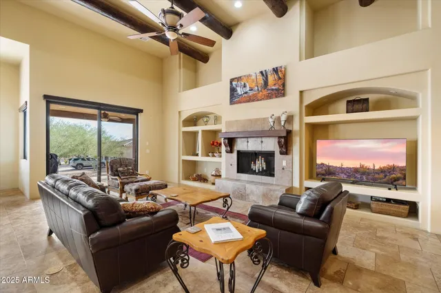 a living room with furniture fireplace and a large window