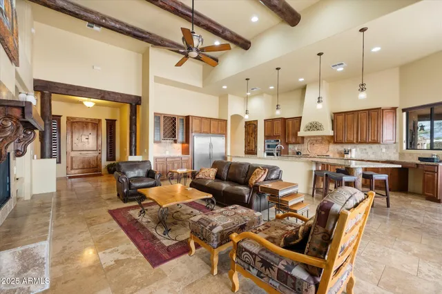 a living room with lots of furniture and kitchen view
