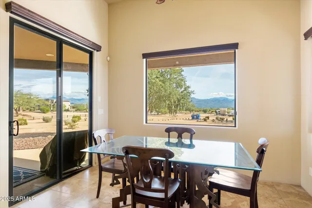 a view of a dining room with furniture large windows and wooden floor