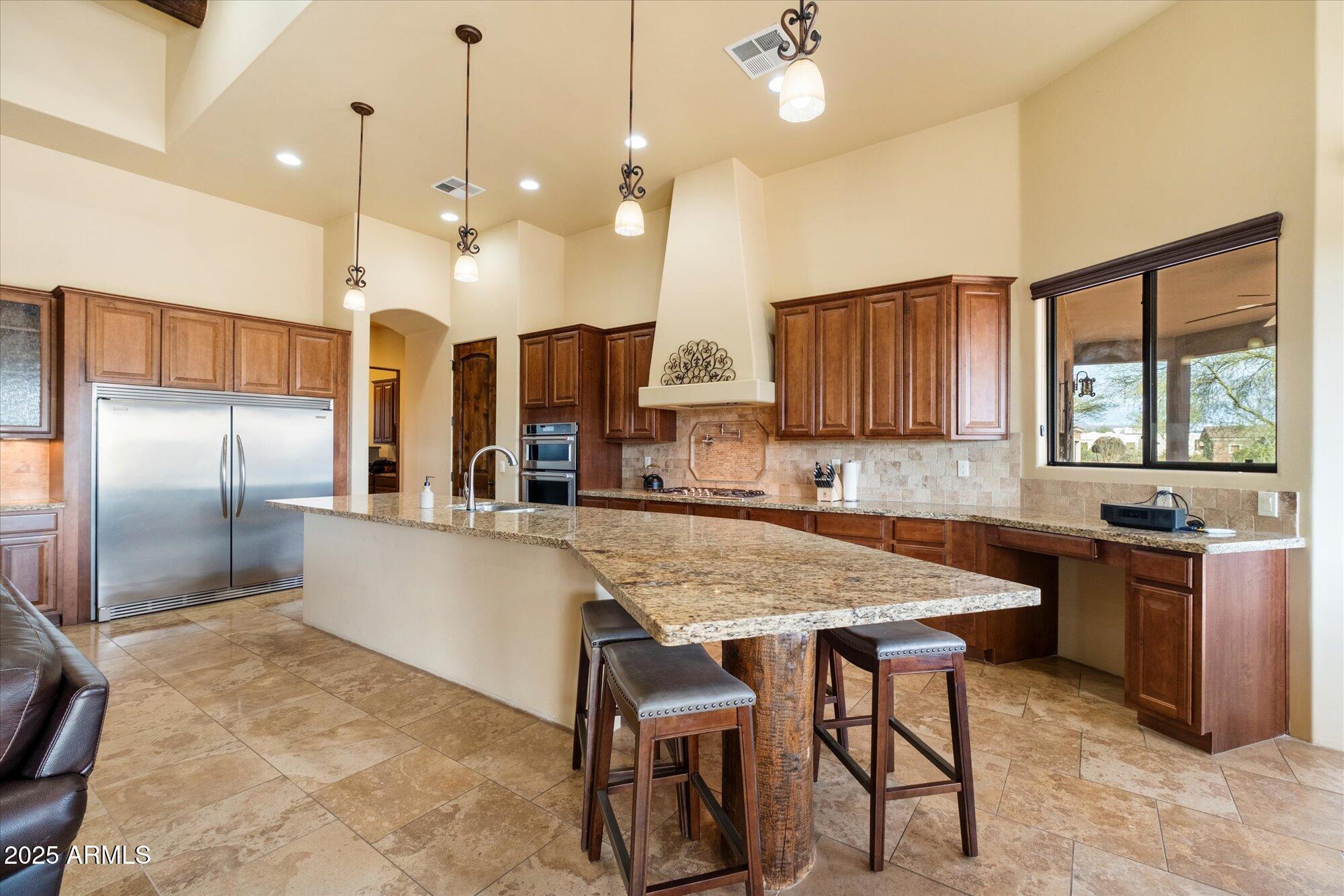 29317 North 164th Street Scottsdale, AZ 85262 - Photo 9 of 27 a kitchen with granite countertop a table chairs stainless steel appliances and window