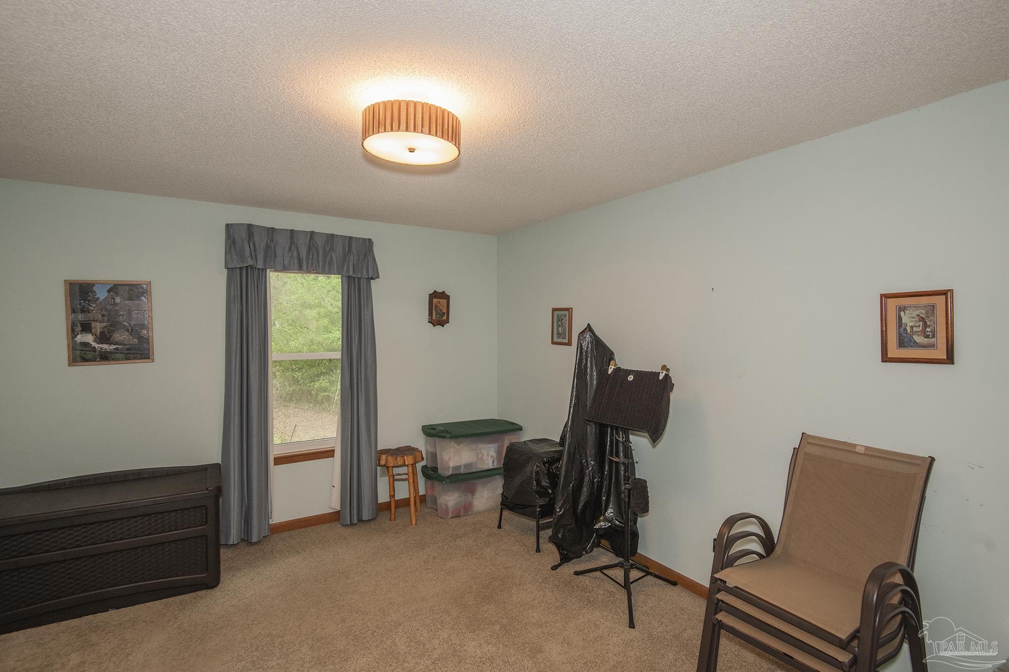 1210 Goldenrod Road Cantonment, FL 32533 - Photo 28 of 50 a view of workspace with lounge chair and windows