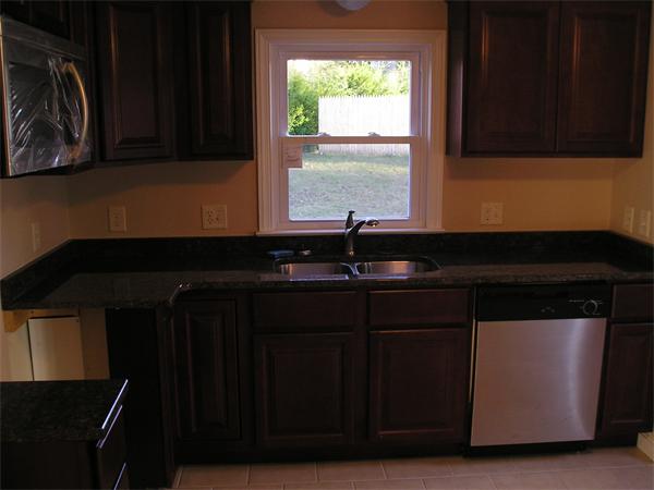 661 Plumtree Road Springfield, MA 01118 - Photo 4 of 10 a close view of a sink a microwave and cabinets