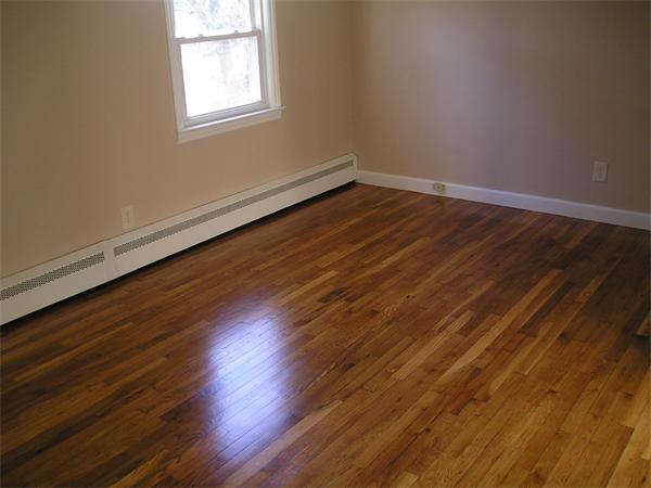 661 Plumtree Road Springfield, MA 01118 - Photo 10 of 10 an empty room with wooden floor and windows