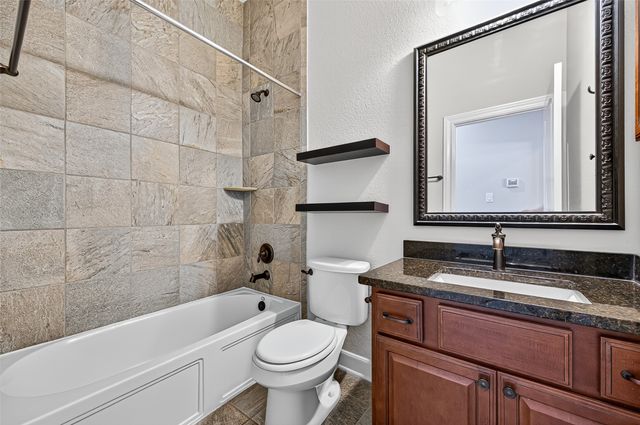 a bathroom with a sink a toilet and bathtub