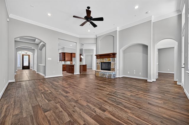 a view of empty room with wooden floor and fireplace