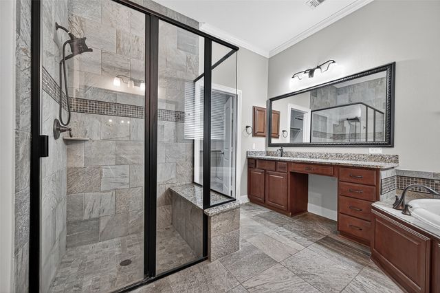 a spacious bathroom with a granite countertop sink mirror and bathtub